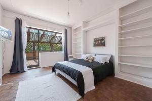 a bedroom with a bed and a large window at Mestre Attico Terrazza by Bricola Apartments in Venice