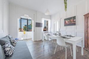 a white dining room with a white table and chairs at Mestre Attico Terrazza by Bricola Apartments in Venice