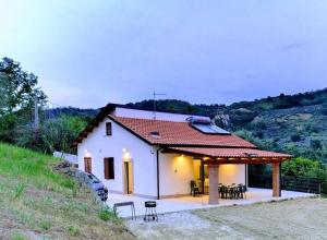 a small white house with a roof at La Casetta di Frank - Country House in Chieti +13 photos