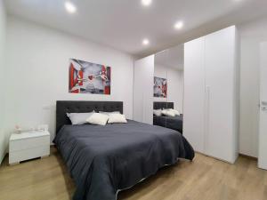 a bedroom with a black bed and a white wall at La Casetta di Frank - Country House in Chieti
