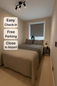 a bedroom with a bed and a window at g-Suites in Tromsø