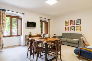 a living room with a table and chairs and a couch at Casa Sulis Holiday Home in Tortolì