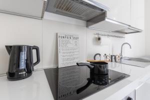 a coffee maker on a counter in a kitchen at Magic Rent - Appartamento Gluck in Milan +10 photos