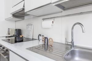 a kitchen with a sink and a counter top at Magic Rent - Appartamento Gluck in Milan