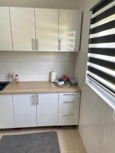 a kitchen with white cabinets and a counter top at Neretva House in Blagaj