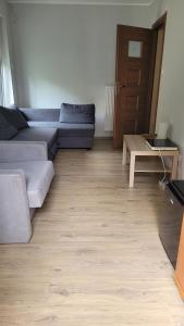 a living room with a couch and a coffee table at Alina SPAnie in Niechorze