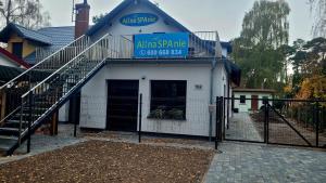 a building with a gate and a sign on it at Alina SPAnie in Niechorze