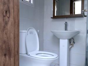 a bathroom with a white toilet and a sink at Luxury House - Sleeps 8 & Free Parking in Abuja +46 photos