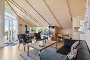 a living room with a couch and a table at 6840-Allinge-Gjedelokken-23 in Allinge