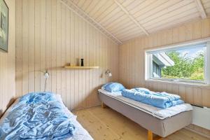 a bedroom with a bed in a room with a window at 6840-Allinge-Gjedelokken-23 in Allinge