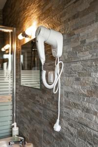 a hairdryer on the wall of a bathroom at Haus Kärnten in Döbriach
