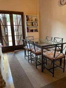 a dining room with a glass table and chairs at Coqueto dúplex - ORDESA l WIFI l VISTAS l GARAJE in Fiscal