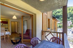 a room with a balcony with a table and chairs at Le Balcon de Barèges - Vue Montagne in Barèges
