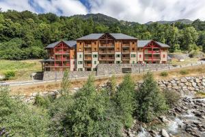 an image of a hotel with mountains in the background at Le Balcon de Barèges - Vue Montagne in Barèges