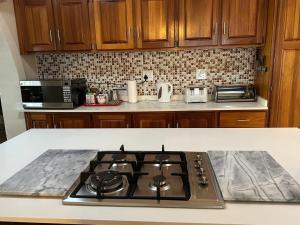 a kitchen with a stove top in a kitchen at Tranquil view lodge in Haenertsburg