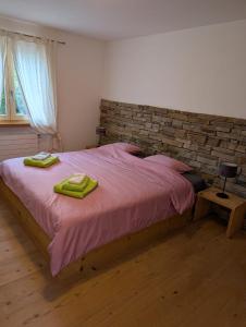 a bedroom with a bed with two towels on it at Wunderschöne 3 Zimmerwohnung mit Bergblick in Celerina in Celerina