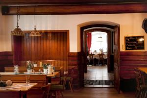 a dining room with tables and chairs and a doorway at Hoftaverne Ziegelböck in Vorchdorf