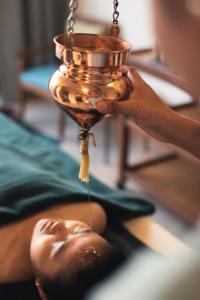 a person is laying on a hospital bed with a jar at TUI BLUE Angkor Grace Wellness Resort in Siem Reap +105 photos