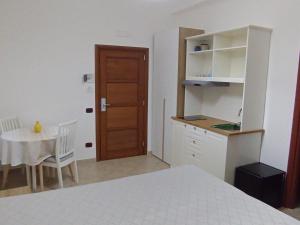 a bedroom with a bed and a table and a door at Regency House Accoglienza in Portici