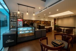 a restaurant with a man standing behind a counter at Hotel Bengal Canary Park in Dhaka