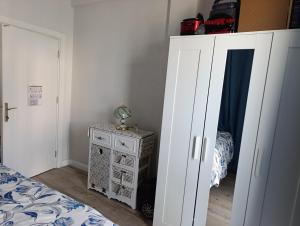 a bedroom with a bed and a white cabinet at side side in Side