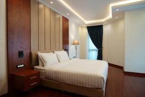 a bedroom with a large bed and a window at Crescent International Hotel in Addis Ababa +79 photos