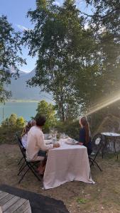 a group of people sitting at a table eating at Vollsnes Glamping in Stryn