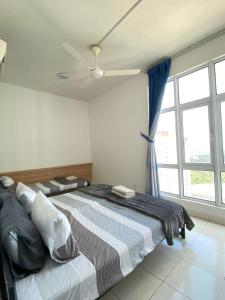 a bedroom with a large bed with a ceiling fan at Apartment Deluxe Mesahill Nilai in Nilai +39 photos