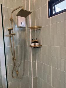 a shower with a shower head in a bathroom at Srithanu Escape 4 in Ko Phangan +23 photos
