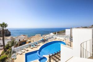 a view of the pool and ocean from the balcony of a hotel at Casa Carvoeiro Bay J in Carvoeiro