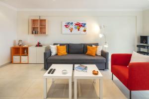 a living room with a couch and a table at Casa Carvoeiro Bay J in Carvoeiro