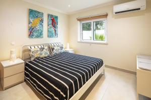a bedroom with a bed and a window at Casa Carvoeiro Bay J in Carvoeiro +16 photos