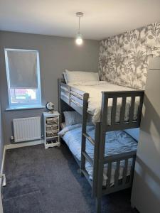 a small bedroom with a bunk bed and a window at 14 Lumb close in Swindon
