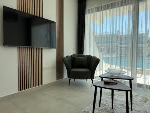 a living room with a chair and a table at Modern Seaside Studio at Northern Cyprus - Pearl Island in Pyla