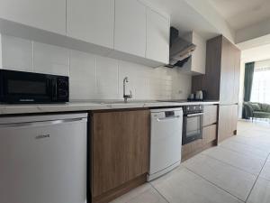 a kitchen with a sink and a microwave at Modern Seaside Studio at Northern Cyprus - Pearl Island in Pyla