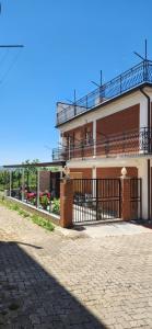 a building with a fence in front of it at Casa Richiusa Calogero in Blufi