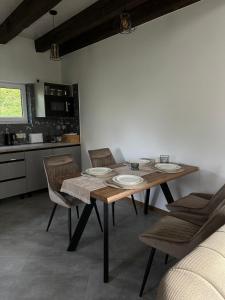 a dining room with a table and chairs and a kitchen at Field house in Slavske