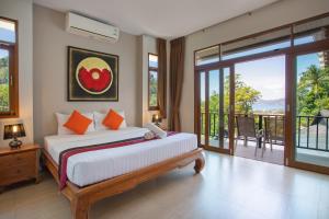a bedroom with a large bed and a balcony at Heavenly Villas in Patong Beach +175 photos