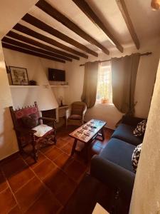 a living room with a couch and a table at Casa La Raspa COZYINNS in Torremolinos