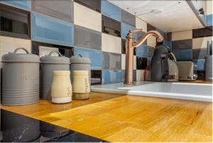 a kitchen counter with several thermos on a wooden counter top at The Merchants House in Hereford