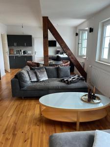 a living room with a couch and a table at Elegantes Apartment in Villa in Ottobeuren