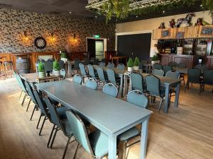 a room with tables and chairs in a restaurant at Eetcafé Punt in Roelofarendsveen