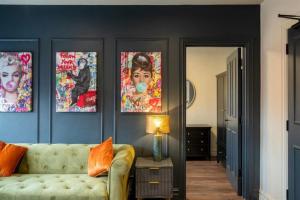 a living room with a couch and posters on the wall at Apartment 1 - Devonshire Square in Loughborough