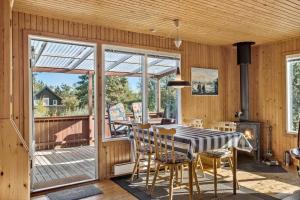 a dining room with a table and chairs on a deck at OH511-Hadsund-Halvrebene-36 in Hadsund