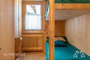 a bunk bed in a wooden room with a window at Dimora del Corso Cortina in Cortina dʼAmpezzo +12 photos