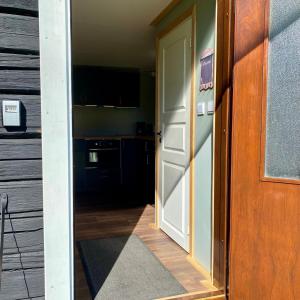 an open door leading to a kitchen with a stove at Villa Ragunda in Hammarstrand