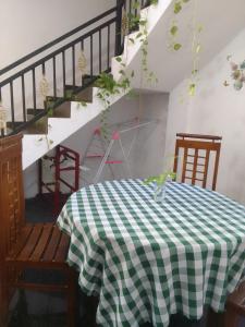 a table with a green and white checkered table cloth at Villa Tharu Hikkaduwa in Hikkaduwa