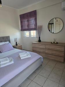 a bedroom with a large bed and a mirror at V & G House in Tripoli