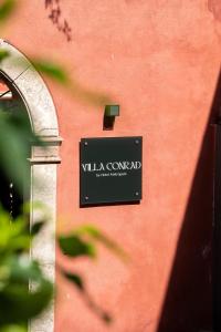 a sign on the side of a building at Villa Conrad in Taormina