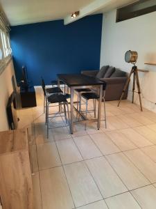 a table and chairs in a living room with a couch at Le Cocon in Meudon +2 photos